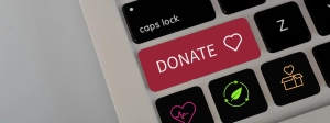 A laptop keyboard with a red "Donate" button